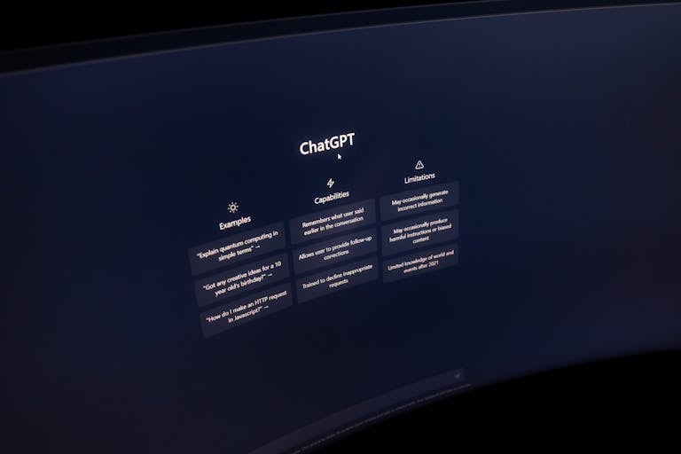 Close-up of a computer screen displaying ChatGPT interface in a dark setting.
